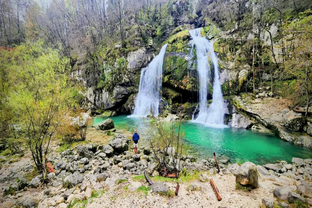 Waterfall with turquoise pool in a forest setting near Bled, Slovenia