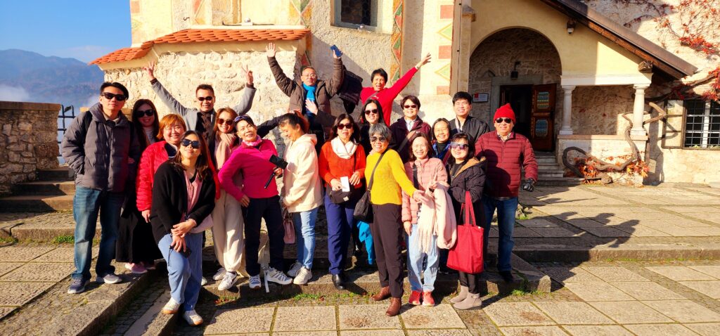 Group of visitors at Bled Castle overlooking Lake Bled, Slovenia