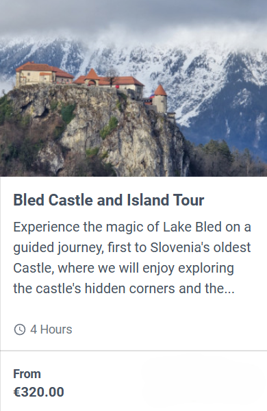 Bled Castle on a rocky cliff above Lake Bled with snow-covered mountains in the background, Slovenia